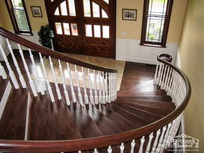 Grand staircase inside custom built home by Brecknock Builders