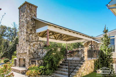 Custom deck and pavilion with stone fireplace and exposed beams