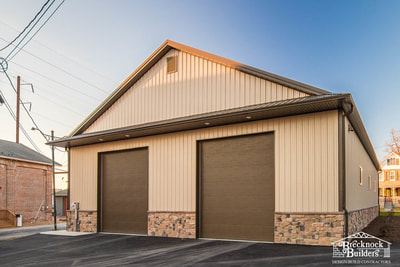 Wood-framed equipment storage and service bays built by Brecknock Builders