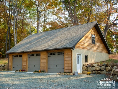 Wood-sided garage with 3 bays